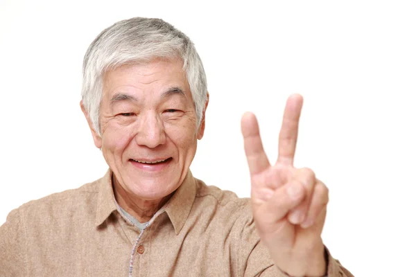 Senior Japanese man showing a victory sign — Stock Photo, Image