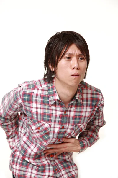 Giovane giapponese soffre di mal di stomaco vuole andare in bagno — Foto Stock