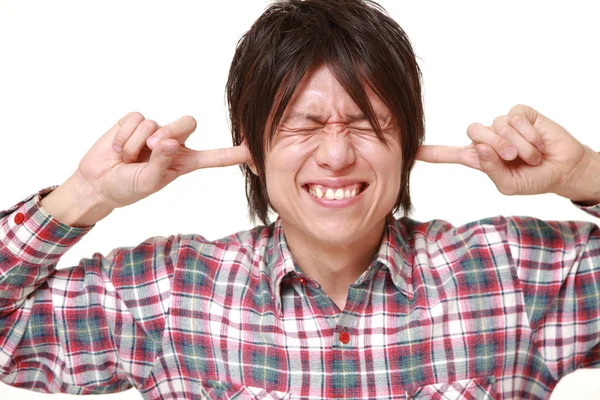 Young Japanese man suffers from noise — Stock Photo, Image