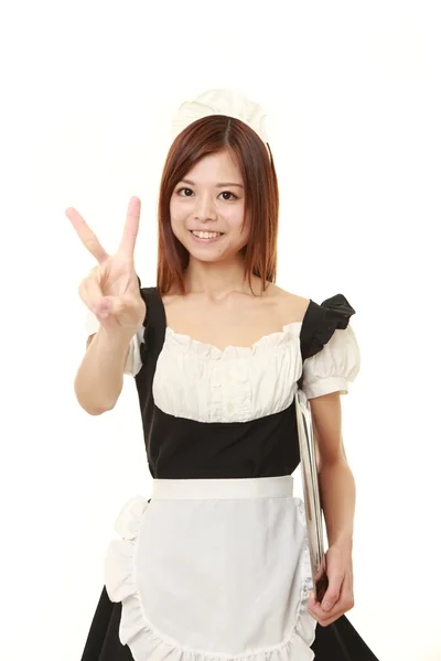 Young Japanese woman wearing french maid costume showing a victory sign — Stock Photo, Image