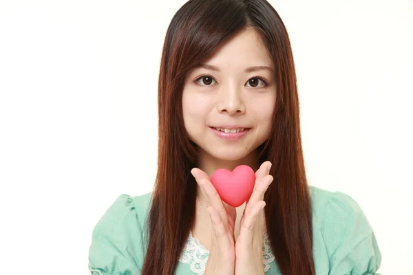Japanese woman with pink heart — Stock Photo, Image
