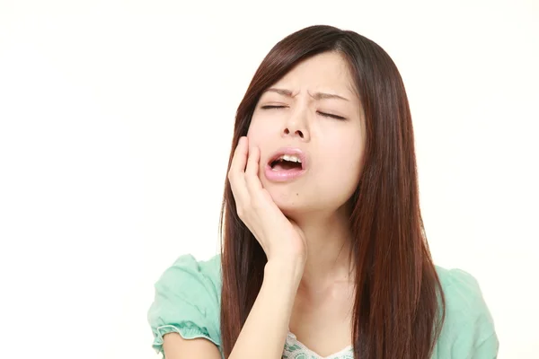 Young Japanese woman suffers from toothache — Stock Photo, Image
