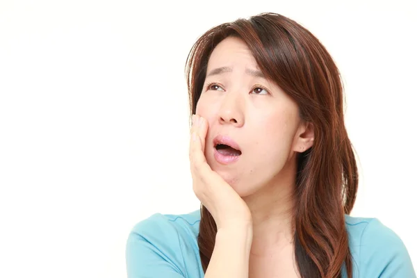 Middle aged Japanese woman suffers from toothache — Stock Photo, Image