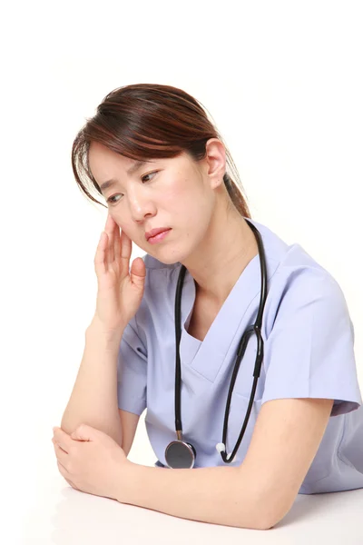 Japanese female doctor worries about something — Stock Photo, Image