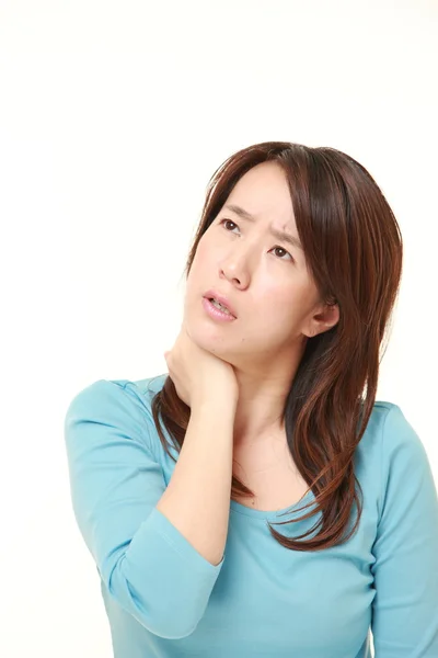 Middle aged Japanese woman suffers from neck ache — Stock Photo, Image