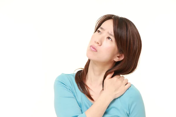 Middle aged Japanese woman suffers from neck ache — Stock Photo, Image