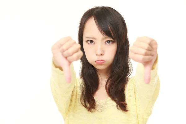 Young Japanese woman with thumbs down gesture — Stock Photo, Image