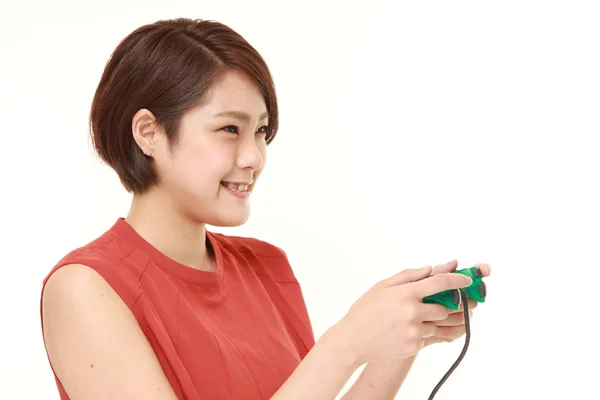 Young Japanese woman enjoying a video game — Stock Photo, Image