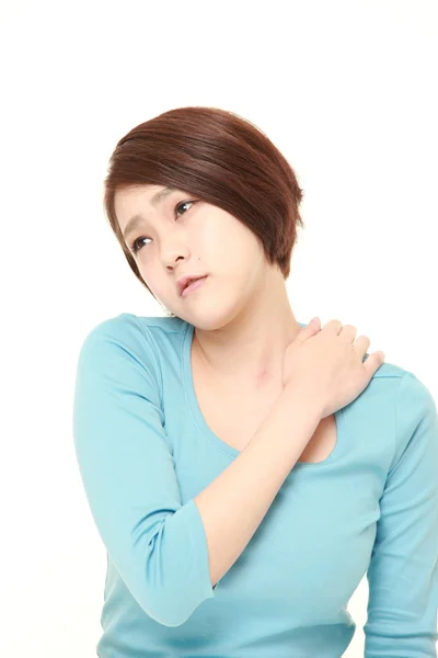 Young Japanese woman suffers from stiff neck — Stock Photo, Image