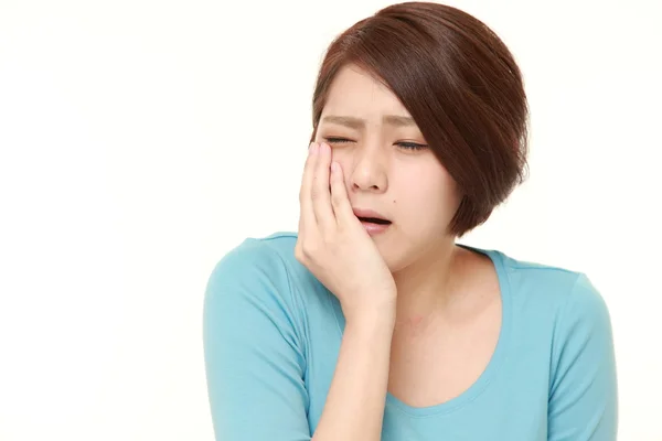 Young Japanese woman suffers from toothache — Stock Photo, Image