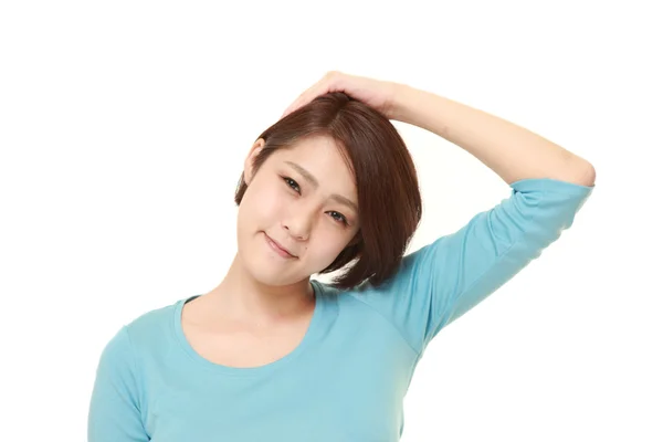 Young woman doing self neck stretch — Stock Photo, Image