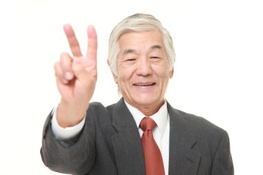 zafer işaret gösteren üst düzey Japon işadamı