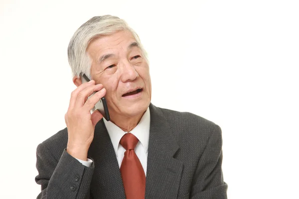 Empresário sênior com um telefone inteligente — Fotografia de Stock