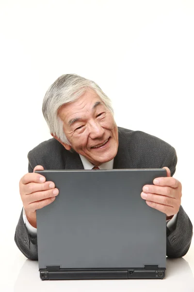 Senior Japanese  businessman  hugging his laptop computer — Stock Photo, Image