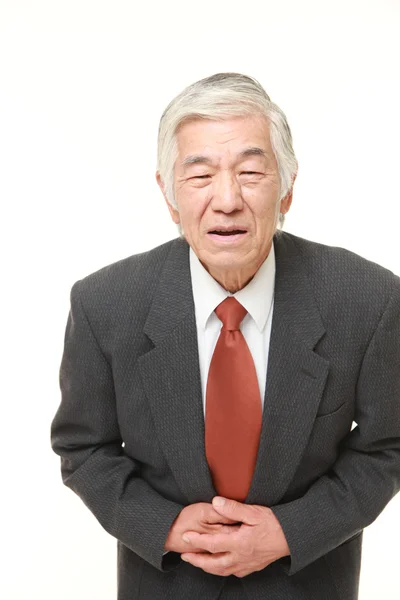 Empresário japonês sênior sofre de dor de estômago — Fotografia de Stock