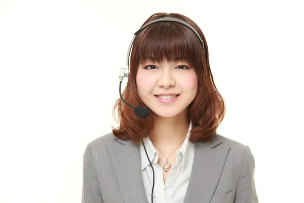 Jonge Japanse zakenvrouw van callcenter met hoofdreeksen — Stockfoto