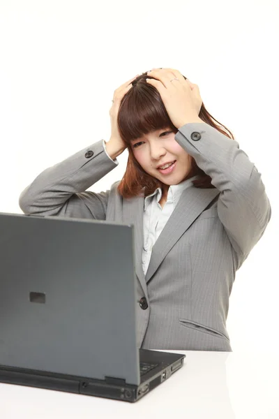 Panicking young Japanese businesswoman — Stock Photo, Image