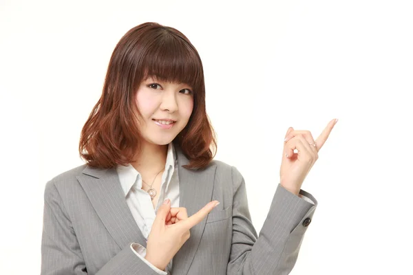 Young Japanese businesswoman presenting and showing something — Stock Photo, Image