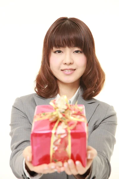 Unga japanska affärskvinna erbjuder en gåva — Stockfoto