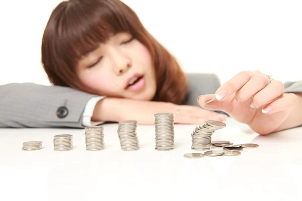 Stack of coins collapsed when businesswoman put a coin — Stock Photo, Image