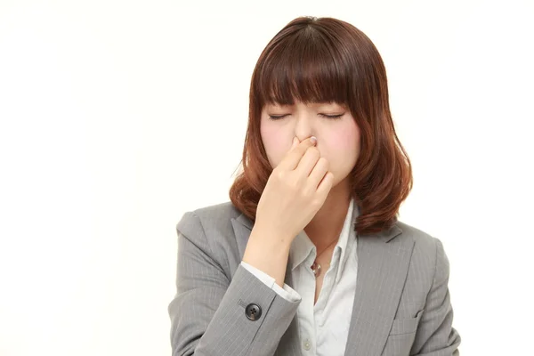 嫌なにおいのため彼女の鼻を保持している日本の実業家 — ストック写真