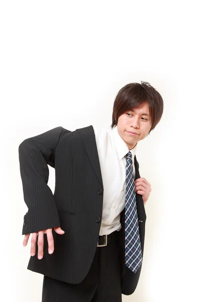 Young Japanese businessman getting dressed for office — Stock Photo, Image
