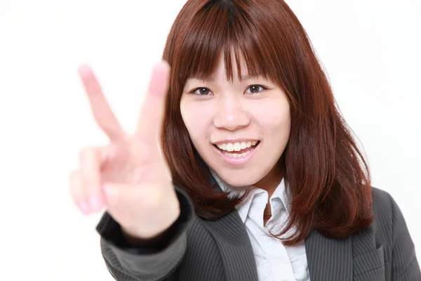 Young Japanese businesswoman showing a victory sign — Stock Photo, Image