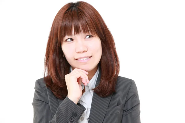 Jeune femme d'affaires japonaise pense à quelque chose — Photo