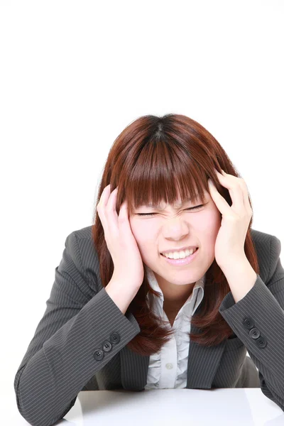 Young Japanese businesswoman suffers from headache — Stock Photo, Image