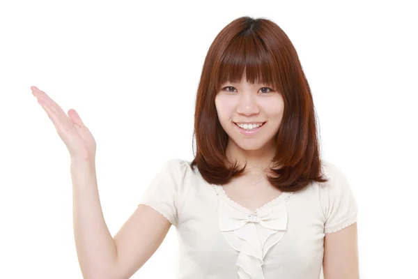 Joven japonesa mujer presentando y mostrando algo —  Fotos de Stock