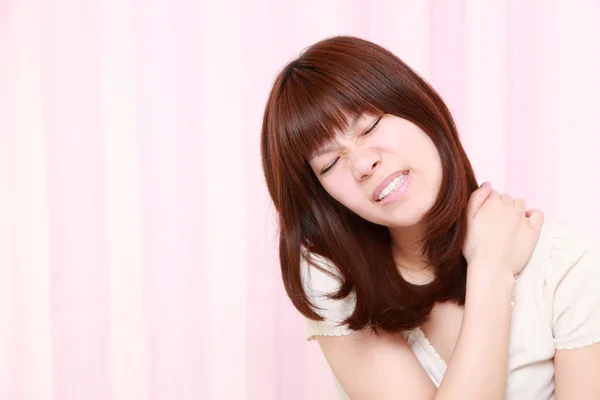 Portrait of young Japanese woman suffers from neck ache — Stock Photo, Image