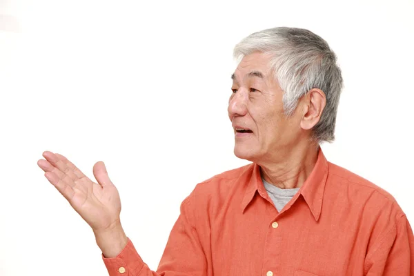 Senior japonés hombre presentando y mostrando algo —  Fotos de Stock