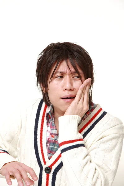 Young Japanese man suffers from toothache — Stock Photo, Image