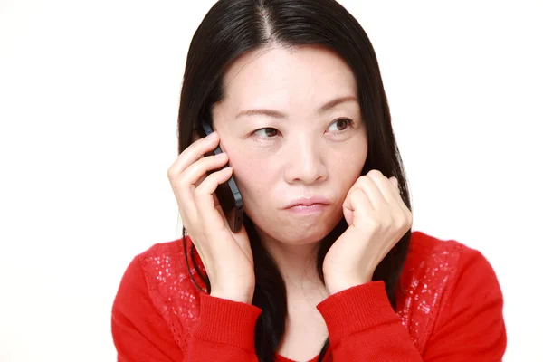 Japanese woman receiving bad news — Stock Photo, Image