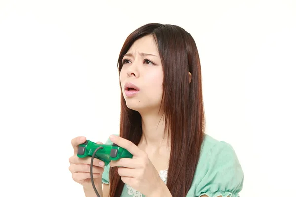 Young Japanese woman losing playing video game — Stock Photo, Image