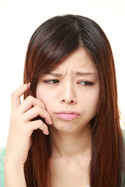 Young Japanese woman worries about something — Stock Photo, Image