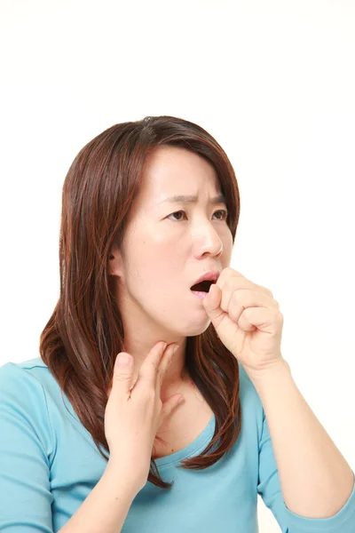 Middle aged Japanese woman coughing — Stock Photo, Image