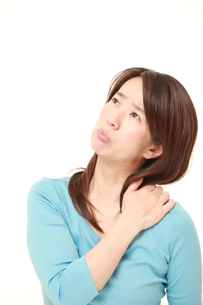 Middle aged Japanese businesswoman suffers from neck ache — Stock Photo, Image