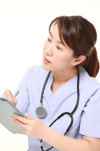 Female doctor fills in clinical record — Stock Photo, Image