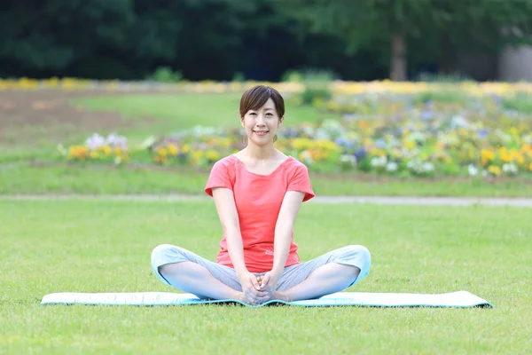 Japonês mulher fora fazendo alongamentos exercício — Fotografia de Stock
