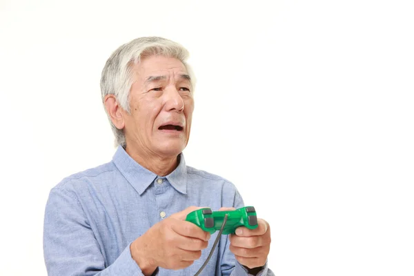 Senior Japaner verliert Videospiel — Stockfoto