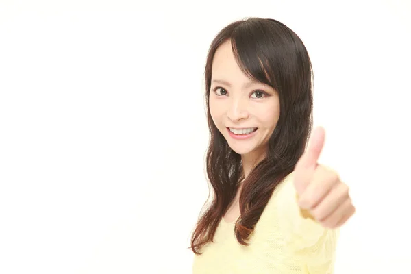 Young Japanese woman with thumbs up gesture — Stock Photo, Image