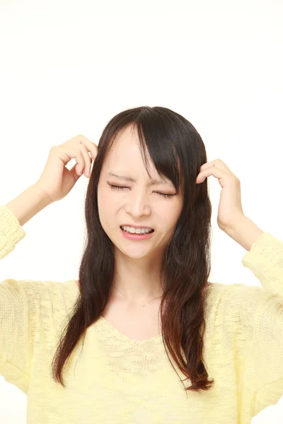 Young Japanese woman suffers from headache — Stock Photo, Image