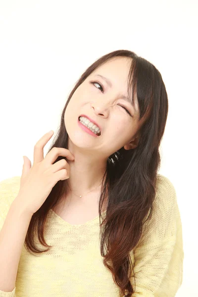 Japanese woman scratching her neck — Stock Photo, Image