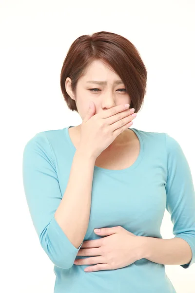 Young Japanese woman feels like vomiting — Stock Photo, Image