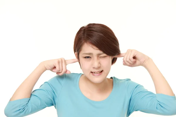 Young Japanese woman suffers from noise — Stock Photo, Image