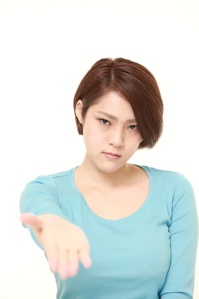 Angry young Japanese woman asks something — стоковое фото