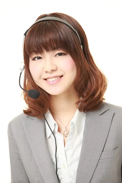 Jonge Japanse zakenvrouw van callcenter met hoofdreeksen — Stockfoto
