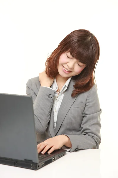 Japanese businesswoman suffers from neck ache — Stock Photo, Image