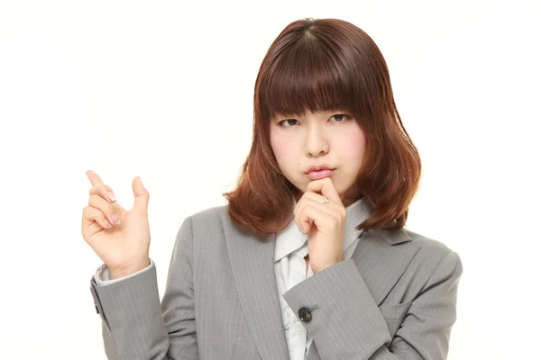 Young Japanese businesswoman doubting — Stock Photo, Image